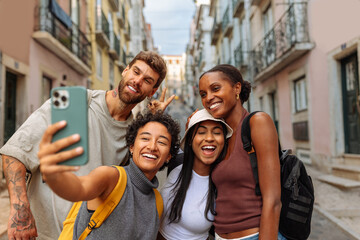 Happy tourists taking a photo of themselves in lisbon, portugal