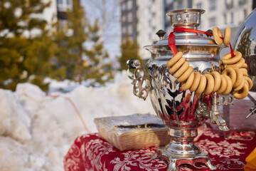 A traditional Samovar paired with bagels displayed against a vibrant urban backdrop