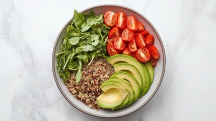 A vibrant bowl containing avocado, cherry tomatoes, leafy greens, and grains, showcasing a fresh and healthy meal option.