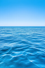 Fototapeta premium Tranquil ocean surface under a vibrant blue sky