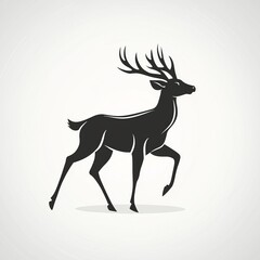 Fototapeta premium Black Silhouette of a Walking Deer with Large Antlers on Light Gray Background