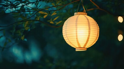 Obraz premium Close-up of a glowing paper lantern gently swaying in the night breeze