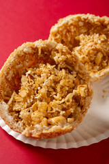 angle view traditional Chinese fried sesame ball on red at vertical composition
