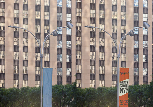 Mockup of a big fly banner hanging from an urban lamppost in  New York.