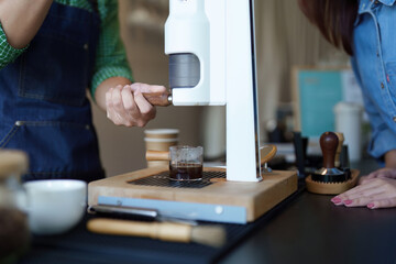 Sustainable Brewing and Coffee Culture. A barista showcasing eco-friendly brewing methods at a modern cafe.