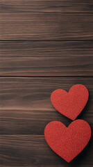 Fototapeta premium Two red hearts on a dark wooden surface