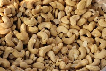 Brown Cashews nut background. Close up shot of Cashew nuts background. Whole Kaju, Kaaju Or Cashew. Many tasty cashew nuts as background, top view. Culture of India, Elegance, Food.
