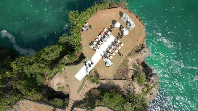 Top view of wedding ceremony on the cliff by the ocean in Bali, Indonesia
