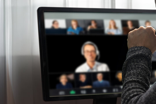 Closeup of man having webcam group digital conference at home. Man using his computer for a virtual discussion, highlighting remote communication and problem-solving in an online conference at home