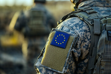Close-up of a European soldier wearing a military uniform with a EU flag patch on his arm.