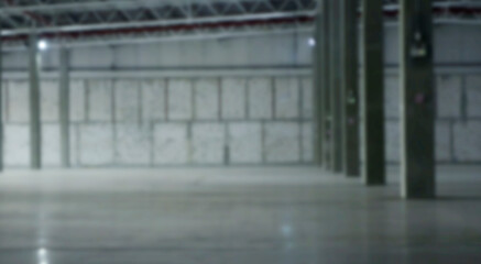 Blur an empty industrial warehouse with large, clean windows, atmospheric light, white.