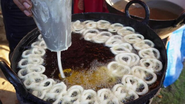 A Person making  Crispy Crunchy and Juicy jalebi