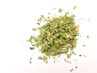 Chopped pile of parsley leaves on a white background.