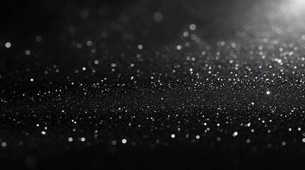Abstract black and white background with shimmering particles and bokeh effect, resembling a starry night sky or cosmic scene