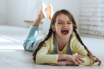The child lost a tooth. A child without a tooth. Portrait of a little girl without a tooth. A baby tooth fell out. A beautiful little girl.
