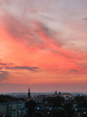 Wawel Royal Castle and Church of St. Catherine standing out against the Krakow skyline under a vibrant, burning sunset sky, creating a picturesque cityscape. burning sunset over Krakow, Poland