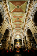 The interior of the Basilica of St. Michael the Archangel on Skałka in Kraków, Poland, showcases magnificent Baroque architecture, adorned with intricate gold detailing, frescoes, and religious iconog