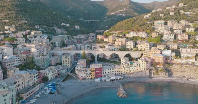An aerial view of Bogliasco in the Liguria region of Italy. The colorful beach houses, historic stone bridge and natural beauty of the Mediterranean coast are dazzling.