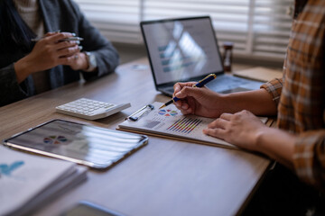 A woman is writing on a piece of paper with a pen
