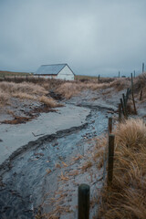 Moody Coastal Landscape in Ogna, Norway – Rustic Barn and Sand Dunes