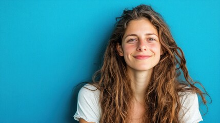 Cheerful long-haired girl exudes joy, vibrant energy radiates in a creative moment.