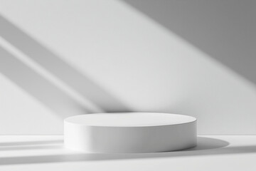 cylindrical platform or pedestal in a neutral, white setting. The composition is simple and modern, with an emphasis on symmetry and negative space.