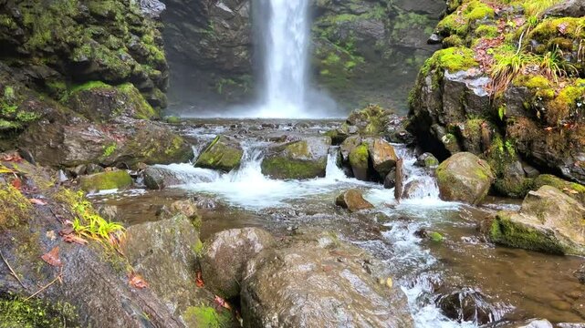 Holy waterfall of Abkhazia on a cloudy winter day in the mountains of the Caucasus. Mountain cascade waterfall. Eastern Abkhazia. Not far from the town of Tkvarcheli. Akarmara district.