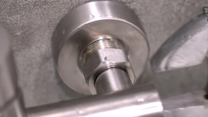 Skilled technician using adjustable wrench to tighten metal pipe nut during detailed maintenance of plumbing, faucet water faucet.