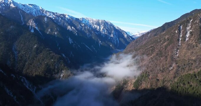 aerial view timelapse of winter mountain valley with mist floating in the air at early spring morning in Sichuan China