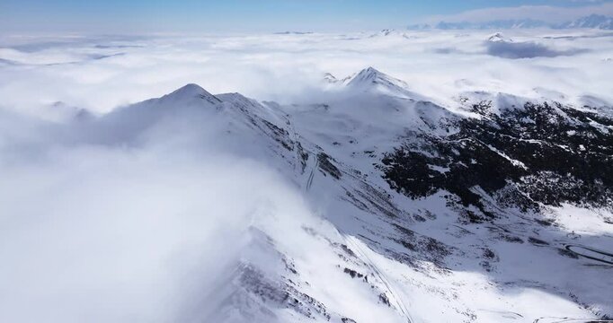 Aerial time lapse of Snow mountain of Jiajinshan in Sichuan China with clouds and mist, amazing nature landscape