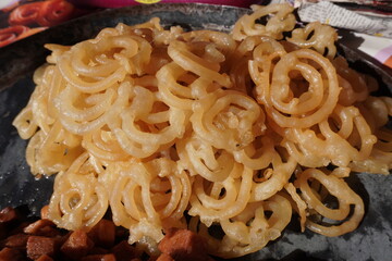Jalebi, a popular sweet from South Asia which is made by deep-frying a fermented batter of maida flour in pretzel or circular shapes and then soaking it in sugar syrup