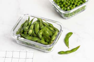 green peas in glass container for storage and cooking, healthy lifestyle, vegetable protein, potassium, fiber