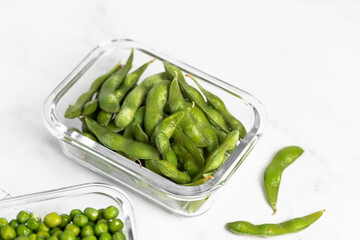 green peas in glass container for storage and cooking, healthy lifestyle, vegetable protein, potassium, fiber