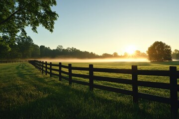 Fototapeta premium Sunrise over a tranquil horse pasture with a wooden fence and mist Generative AI