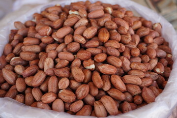 A pile of roasted peanuts, also known as groundnuts which are the seeds of a legume crop grown for its edible seeds