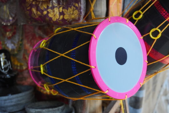 Traditional Indian Dhol Drum showcasing for sale in a market 