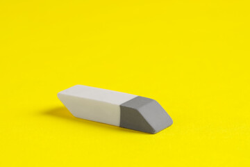 One eraser on yellow background, closeup view