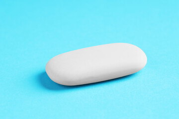 One eraser on light blue background, closeup