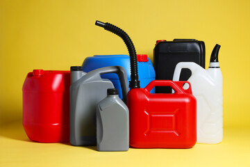 Many different plastic canisters on yellow background