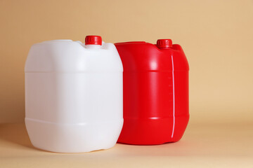 Two clean plastic canisters on beige background