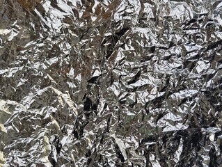 Abstrak crumpled silver metalic plastic texture background 