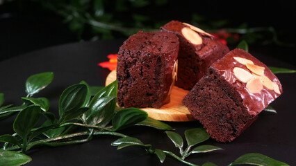 Dark chocolate brownies with crunchy almond topping slices, showing the details and depth of the...