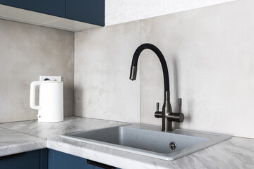 kitchen faucet on a stylish metal sink