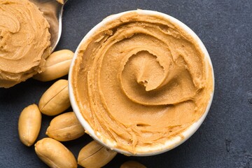  Delicious and healthy peanut butter on black background