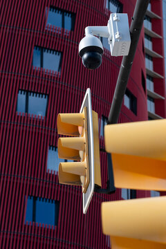 Abstract composition of stacked traffic lights with security cameras in an urban setting, symbolizing control and surveillance.