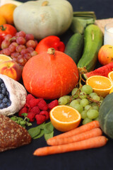 Various healthy fruits, vegetables and cereals on dark background. Selective focus.