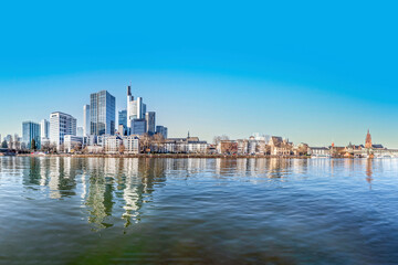 Obraz premium view to modern skyline of Frankfurt wit skyscraper and. with river Main in foreground