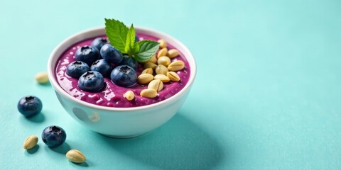 A vibrant purple smoothie bowl topped with fresh blueberries and crunchy nuts, a delicious and healthy breakfast or snack option.