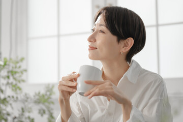 コーヒーカップを持つ女性