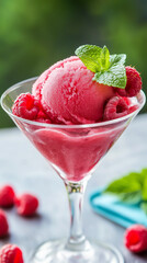 Refreshing Raspberry Cocktail with Mint Garnish in Elegant Martini Glass on Vibrant Green Background